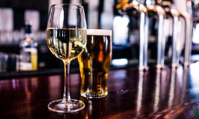 Close up of a glass of wine and a beer in a bar
